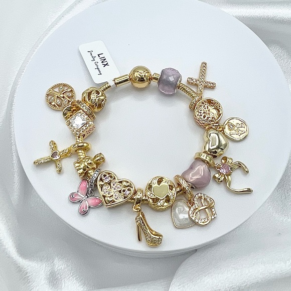 Linx Yellow Gold Snake Chain Bracelet with Gold and Pink Religious Themed Charms
